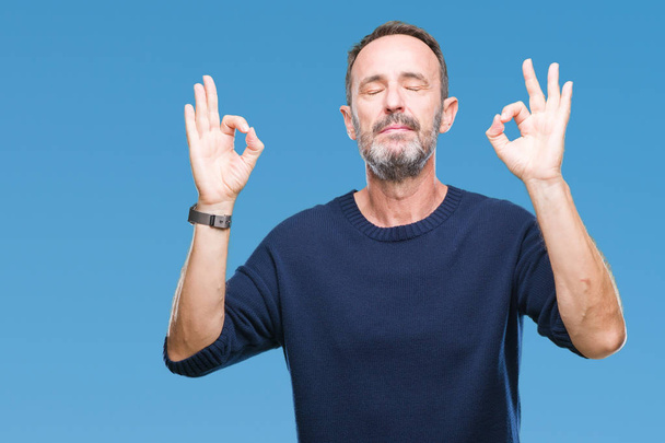 Middle age hoary senior man over isolated background relax and smiling with eyes closed doing meditation gesture with fingers. Yoga concept. - Foto, immagini