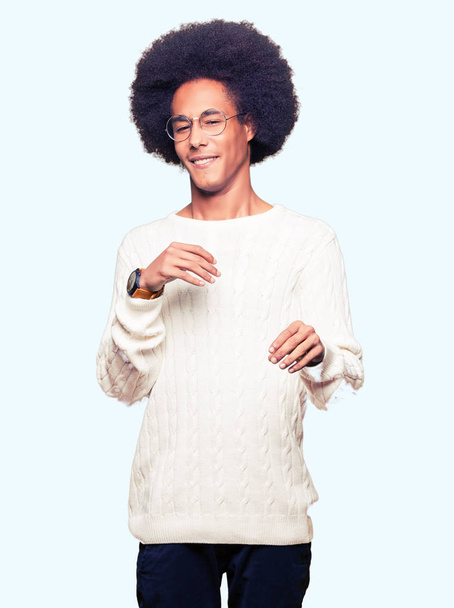 Young african american man with afro hair wearing glasses disgusted expression, displeased and fearful doing disgust face because aversion reaction. With hands raised. Annoying concept. - Fotografie, Obrázek