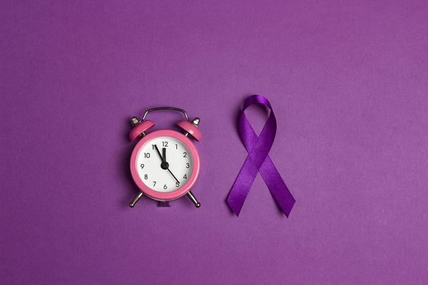 Purple epilepsy awareness ribbon with alarm clock on a purple ba - Fotoğraf, Görsel