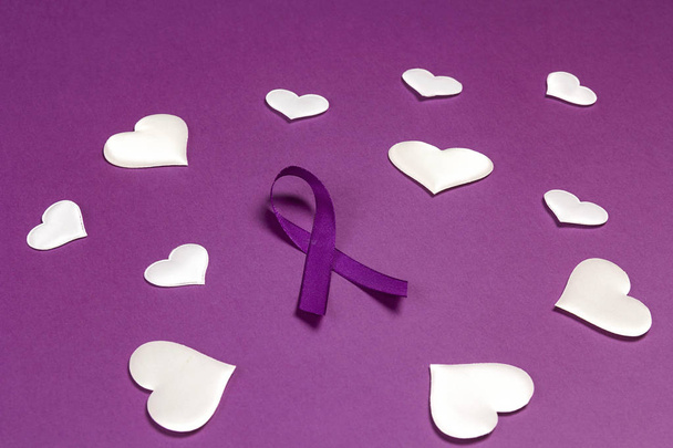 Purple epilepsy awareness ribbon wit white heats on a purple bac - Φωτογραφία, εικόνα