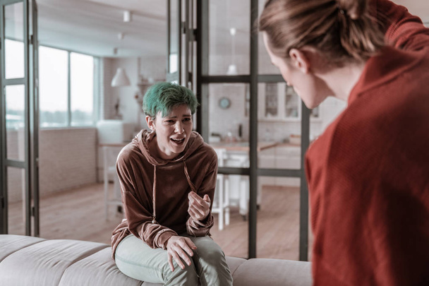 Green-haired woman crying while having argument with husband - Photo, image