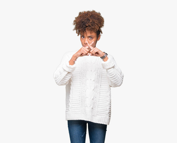 Beautiful young african american woman wearing winter sweater over isolated background Rejection expression crossing fingers doing negative sign - Foto, afbeelding