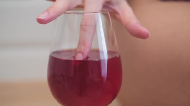 Woman taste wine with finger - Filmati, video
