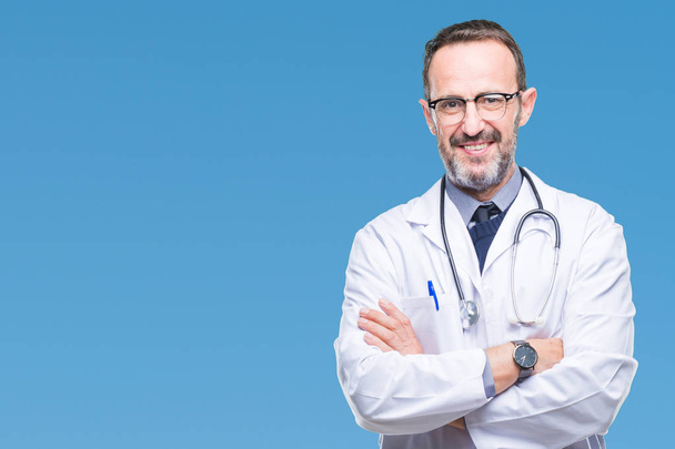 Middle age senior hoary doctor man wearing medical uniform isolated background happy face smiling with crossed arms looking at the camera. Positive person. - Fotó, kép