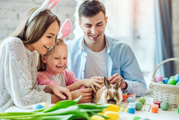 In our family, the festive atmosphere of Easter.Lovely family preparing for Easter together.In the spotlight home decorative rabbit. - Fotografie, Obrázek