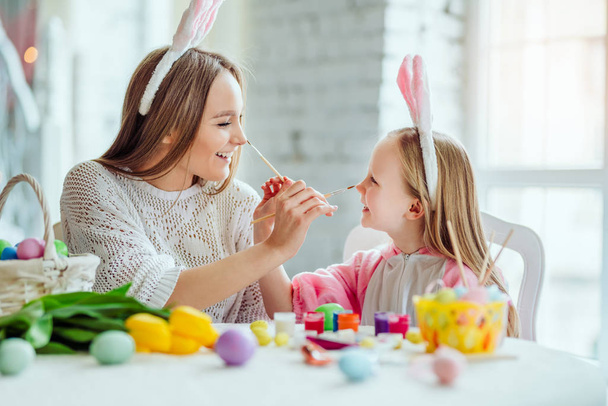 Make a holiday child.Mom and daughter are preparing for Easter together.Mom and daughter have a fun. - Fotografie, Obrázek