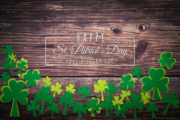 St Patricks Day, golden coins, festive hat and green Shamrocks with Saint Patricks day lettering on wooden - Foto, Bild