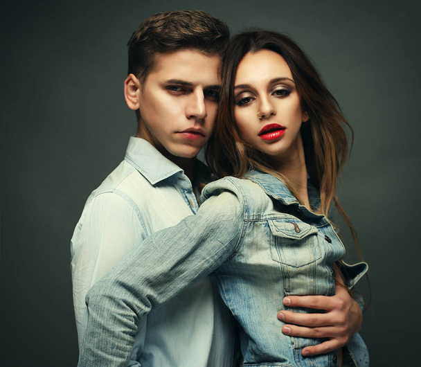 Fashion and people concept: fashion photo of sexy impassioned couple wearing jeans - Foto, Imagen