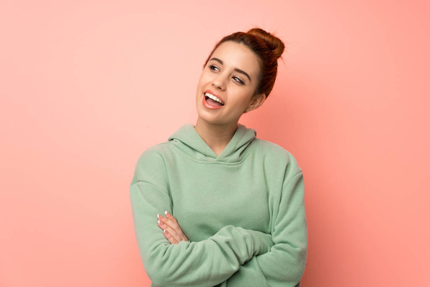 Young redhead woman with sweatshirt Happy and smiling - Photo, Image