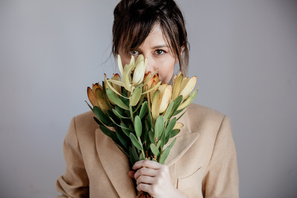 Young woman with bouquet of  Leucadendron - Zdjęcie, obraz