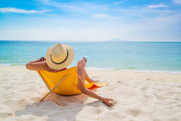 Woman enjoying her holidays on a transat at the tropical beach  - Valokuva, kuva