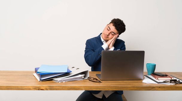 Business man in a office making sleep gesture in dorable expression - Foto, immagini