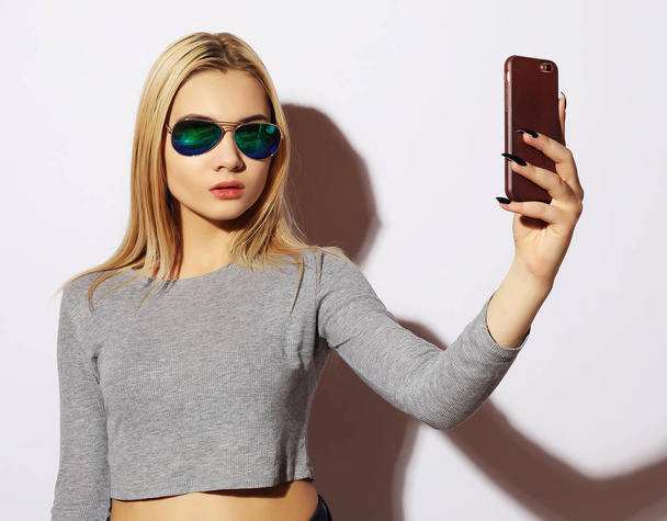  woman making selfie photo on smartphone isolated on a white bac - Photo, image