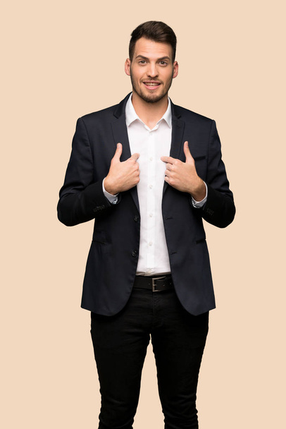 Handsome business man with surprise facial expression over ocher background - Fotografie, Obrázek
