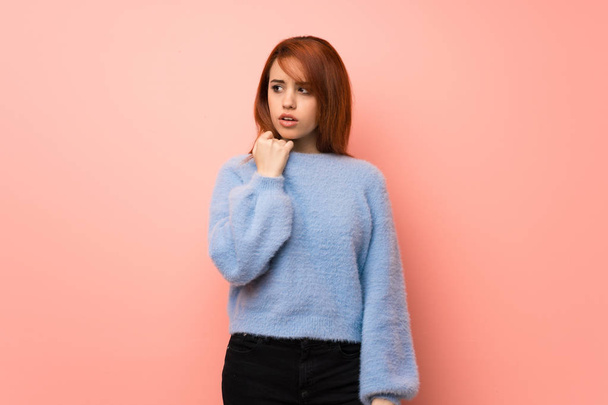 Young redhead woman over pink background with tired and sick expression - 写真・画像