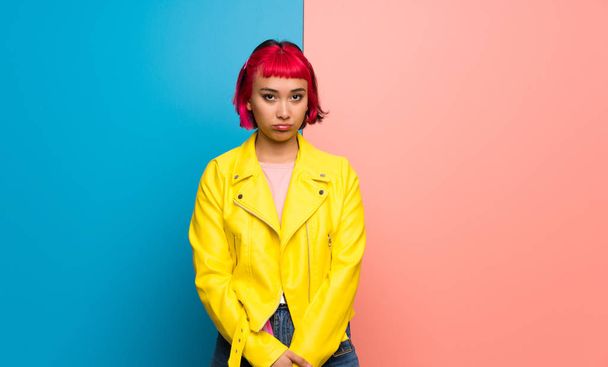 Young woman with yellow jacket with sad and depressed expression - Foto, Imagem