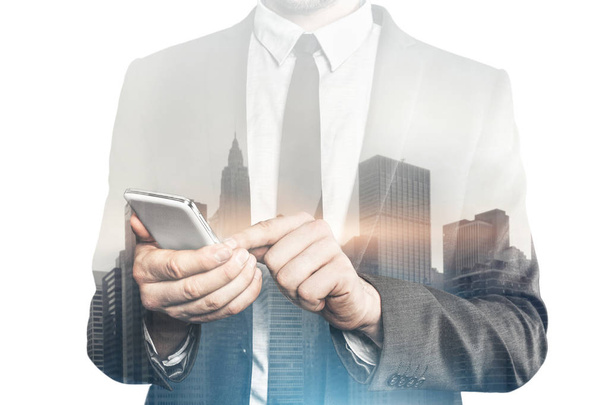 Businessman in a suit using smart phone - Foto, Bild