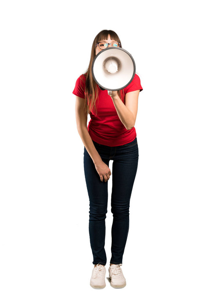Full-length shot of Woman with glasses shouting through a megaphone - Zdjęcie, obraz