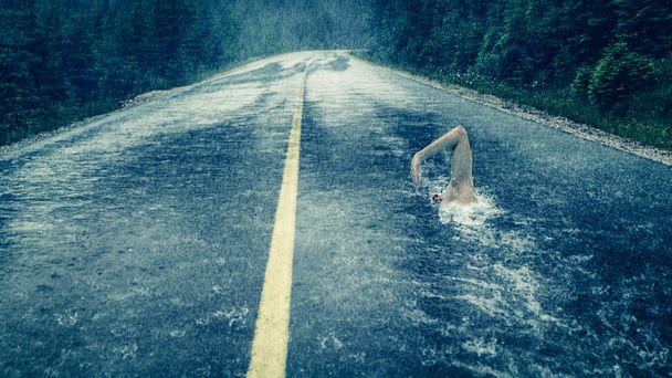 Surreal image with man swimming in asphalt pool - Photo, Image