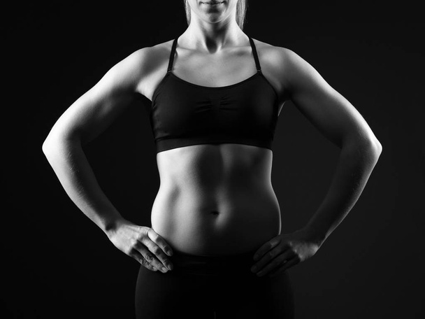 Fit woman posing on dark background - Photo, Image