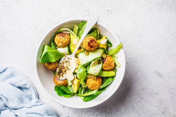 Vegan salad with beans meatballs, avocado and cucumber in white  - Foto, Imagen