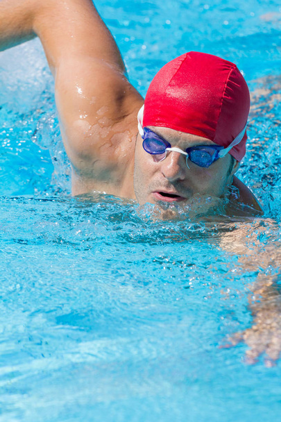 Man swimming in a swimming pool - Fotó, kép