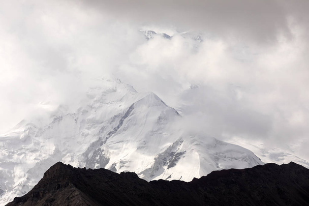 Pamir mountains with peak Lenin, which is shrouded by clouds, Kyrgyzstan - Photo, Image