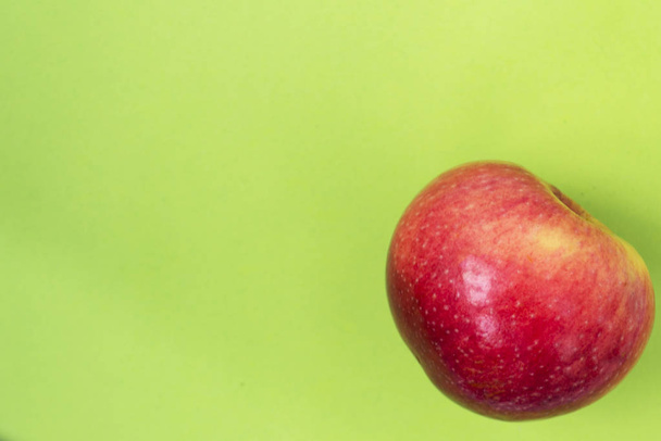 Fresh and red apple on green color background. - Фото, изображение