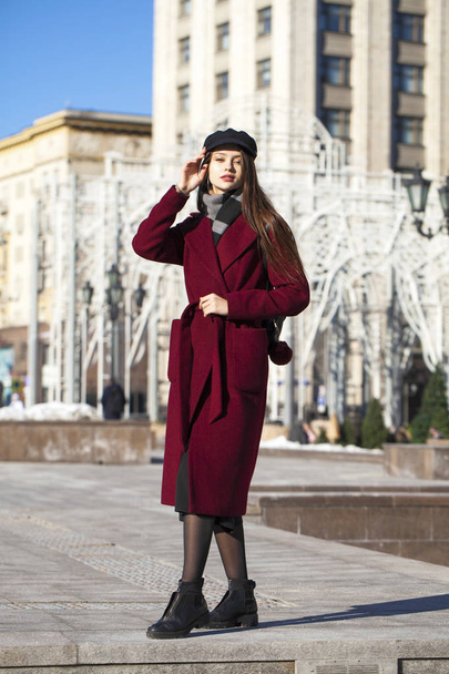 Beautiful girl in stylish in a long burgundy coat - Foto, Imagem
