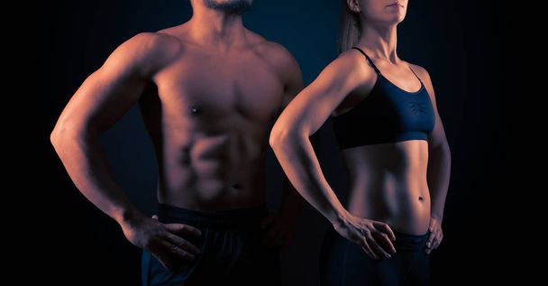Perfectly shaped female and male upper bodies. Fitness, workout and training concept - Zdjęcie, obraz