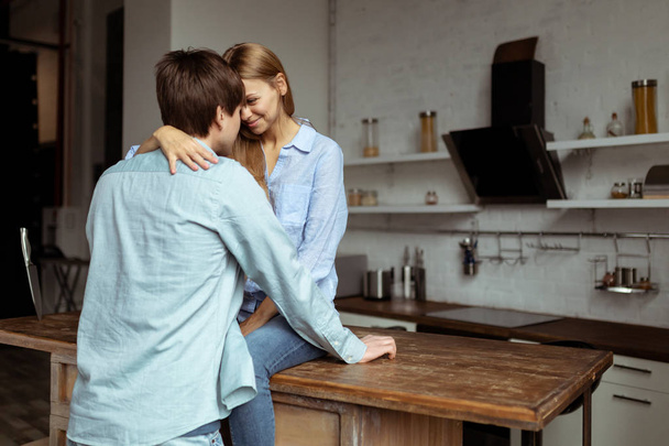 Loving young couple spending time together in the kitchen - Foto, Imagen