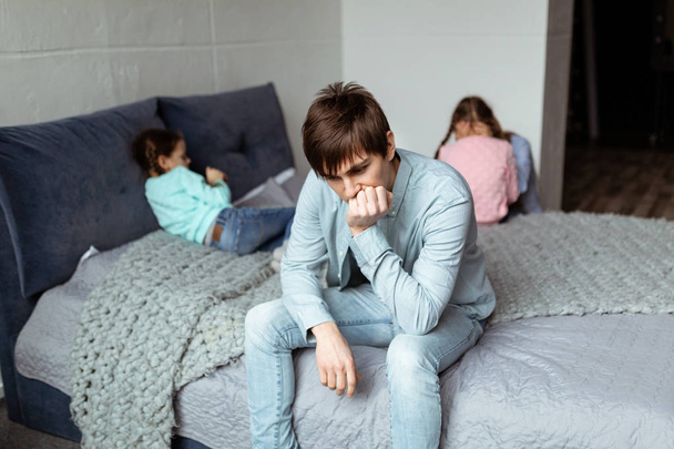 Sad young father sits on the bed after guarrel - Foto, Imagem