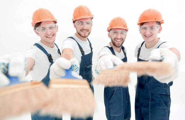 grupo sonriente de constructores con un pincel
 - Foto, Imagen