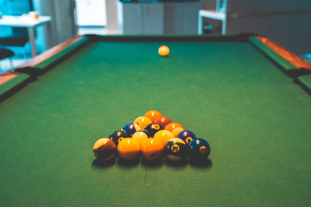 Billiard Balls and a Pool table. A Vintage style photo of a billiard balls on a pool table with a cue stick. - Foto, afbeelding