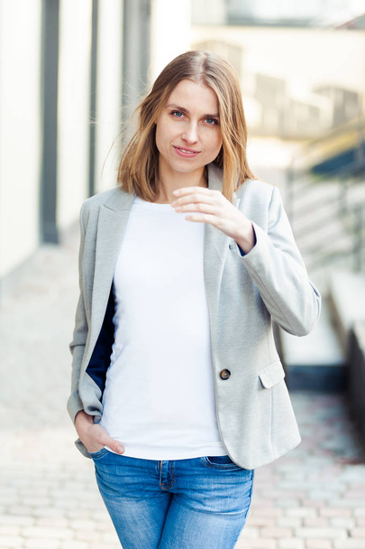 Portrait of beautiful smiling blonde young woman near office company - Fotografie, Obrázek