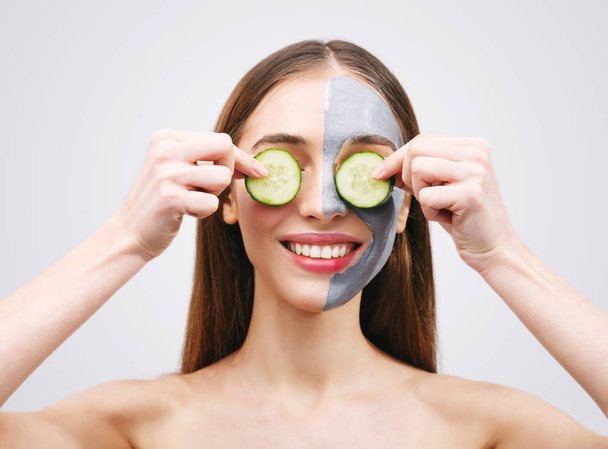 Woman with Clay Mask and Cucumbers - 写真・画像