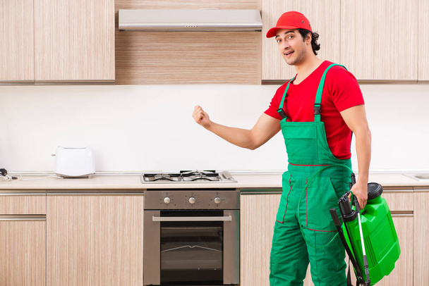 Professional contractor doing pest control at kitchen - Photo, image