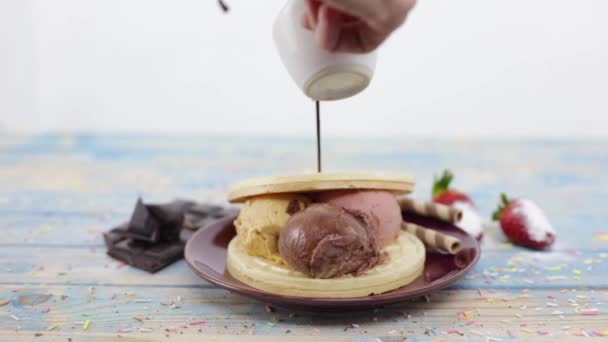 pouring chocolate on ice cream and paper candy - Footage, Video