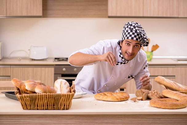 Young male baker working in kitchen  - Photo, Image