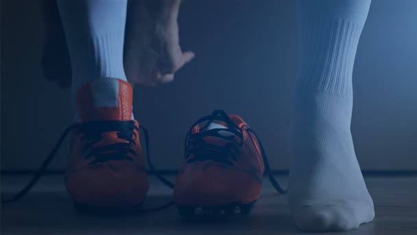 Soccer football player put on his shoes. Slow Motion.  - Felvétel, videó