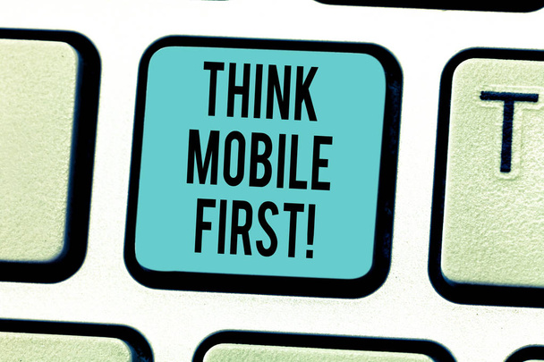 Writing note showing Think Mobile First. Business photo showcasing designing online experience for phones before web Keyboard key Intention to create computer message pressing keypad idea. - Photo, Image