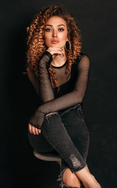 beautiful sexy woman with long blond curly hair in elegant cloth - Fotó, kép