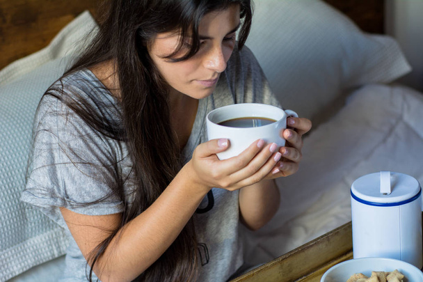 Young woman having breakfast in bed - Фото, зображення