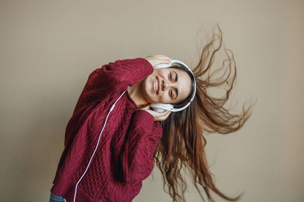 Enjoy the music. Happy young woman pleasing music in headphones. - Fotografie, Obrázek