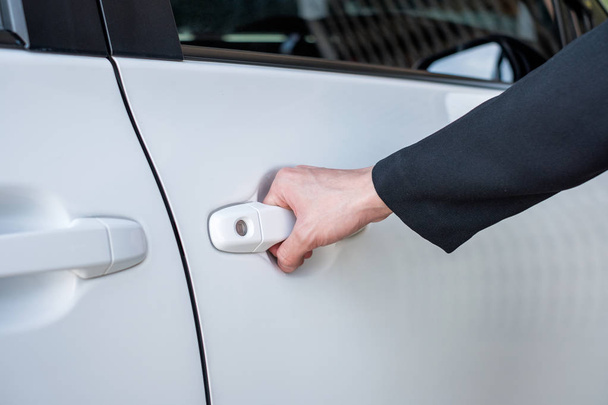 Formal hand on handle opening a car door - Foto, Imagen
