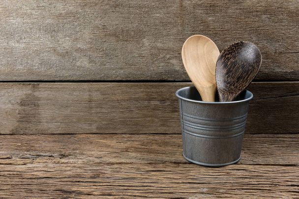 wooden kitchen set skimmer, spade of frying pan in metal box on  - Фото, изображение