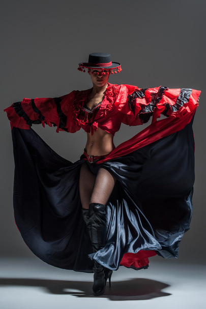 Woman in beautifull red dress dancing in a studio - Fotó, kép