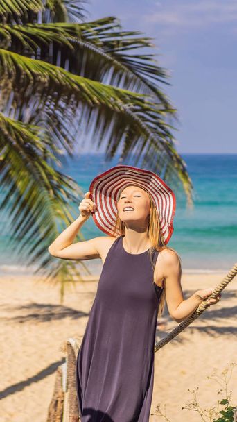 Vacation on tropical island. Woman in hat enjoying sea view from wooden bridge VERTICAL FORMAT for Instagram mobile story or stories size. Mobile wallpaper - Zdjęcie, obraz