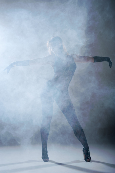 Woman dancing in a smoke. Studio - Фото, изображение