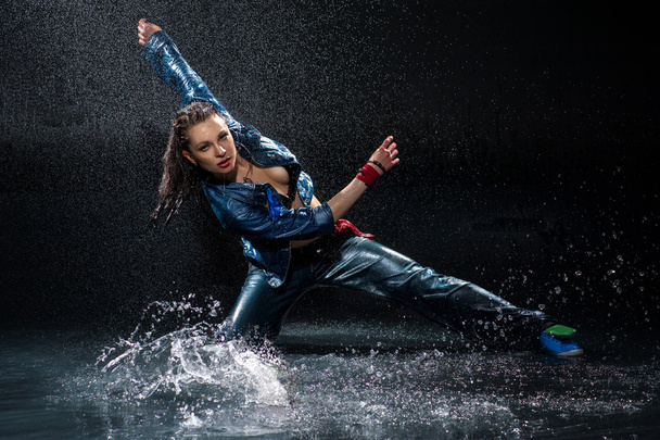 Wet dancing woman. Under waterdrops. Studio photo - Фото, зображення